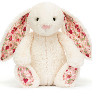 Jellycat Blossom Bunny Berry—this plush bunny has pink floral ears and feet, sitting upright against a white backdrop.