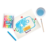 An OOLY robot uses Smooth Stix Watercolor Gel Crayons to draw on paper with a paintbrush nearby.