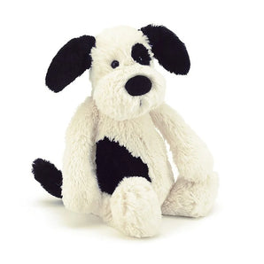 Jellycat Bashful Black & Cream Puppy Medium: a silky-soft plush with floppy black ears, an eye patch, and a spotted side.