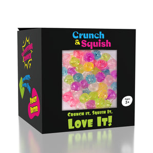 Showcase Crunch & Squish Candy: a black box with colorful beads, sensory toy series for ages 3+, labeled "Love It!.