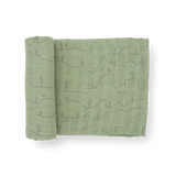 Little Unicorn's Cotton Swaddle, Cactus Lines: green cotton muslin with desert hills and cacti line art, shown partially rolled.