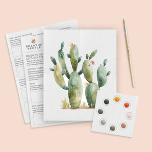 Watercolor Kit, Desert Cactus: cactus illustration on paper, pages of directions, paintbrush, and set of watercolors.