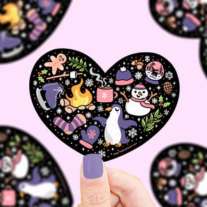 Turtle Soup Vinyl Sticker, Winter Heart: Heart-shaped with penguins, snowflakes, cocoa & mittens. Durable & waterproof on black.