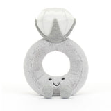 Jellycat Amuseable Diamond Ring is a plush toy shaped like a smiling diamond ring, featuring soft silver fur and charm.