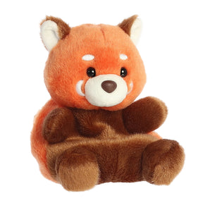 Palm Pals Rei Red Panda by Aurora sits upright, showcasing vibrant fur, expressive eyes, and white cheeks against a white background.
