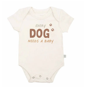 Organic Bodysuit, Every Dog Needs a Baby: white short sleeve bodysuit with text "Every Dog Needs A Baby." Made of 100% organic cotton.