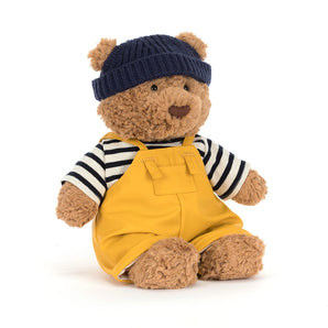 Jellycat Bartholomew Bear Seafarer Outfit: plush bear in navy beanie, striped shirt, and yellow overalls—cute and cuddly!.