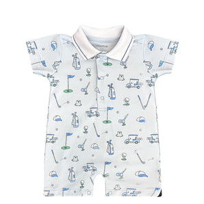 The Noomie Golf Romper features clubs, carts, and flags on a pale base with blue and green accents in Pima cotton.
