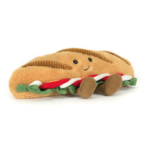 Jellycat Amuseables Caprese: a plush baguette with a smile, soft veggies, and cute brown legs by Jellycat.