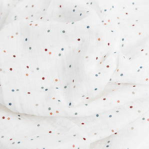 Little Unicorn Cotton Swaddle, Dots: Soft white muslin with colorful polka dots; breathable and gently wrinkled.
