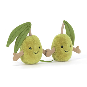 Two plush green pears with smiling faces and leaf arms sit together, as cute as any Jellycat Amuseables Pair of Olives toy.