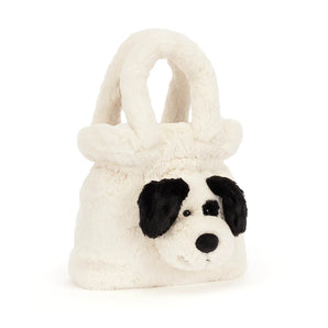 Jellycat, Handbag Rufferty Puppy, a cream-colored plush handbag shaped like a puppy face with black ears and a black eye patch.