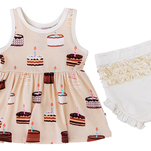 The Blake Birdie Peplum Set by Birdie Bean features a sleeveless cake print dress and ivory ruffled bloomers for a charming look.