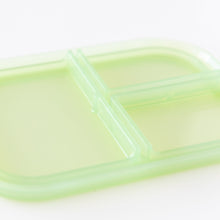 Load image into Gallery viewer, Close-up of the lid of Bumkins Silicone Bento Box 3 Section: Green Jelly, made of LFGB-grade silicone, on a white background.
