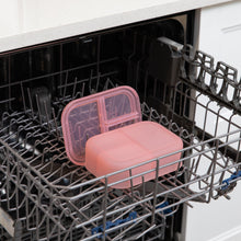 Load image into Gallery viewer, Bumkins Silicone Bento Box 3 Section: Pink Jelly sits in the top rack of an open dishwasher.

