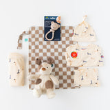The Family Match- Neutral Dog gift set by Zoolikins: dog clothes, hat, blanket, plush, checkered mat & bear rattle on white.