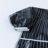 Close-up of Bumkins Sleeved Bib: Jack Skellington on a white background, with focus on the white elastic cuff on the sleeve.