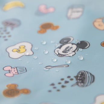 Close-up of water droplets on Bumkins Sleeved Bib: Mickey + Minnie Sunny Side Up.