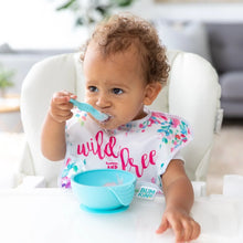 Load image into Gallery viewer, A toddler wearing a floral bib in a high chair enjoys a meal from a Bumkins Silicone First Feeding Set: Blue.
