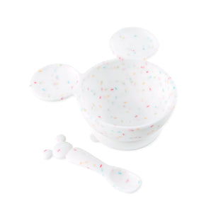 Bumkins Silicone First Feeding Set: Mickey Mouse Vanilla Sprinkle includes a confetti Mickey Mouse-shaped silicone bowl and matching spoon.