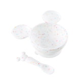 Bumkins Silicone First Feeding Set: Mickey Mouse Vanilla Sprinkle includes a confetti Mickey Mouse-shaped silicone bowl and matching spoon.