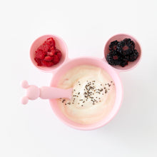 Load image into Gallery viewer, Bumkins Silicone First Feeding Set: Minnie Mouse Light Pink filled with yogurt, chia seeds, and berries on a white background.
