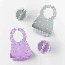 Load image into Gallery viewer, Bumkins Silicone First Feeding Set: Lavender, a gray bowl &amp; spoon, and two gray and purple silicone bibs are arranged on a white background.
