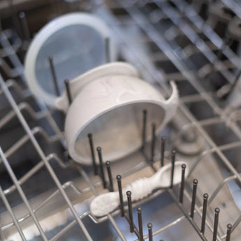 Bumkins Silicone First Feeding Set: Marble sits in the top rack of an open dishwasher.