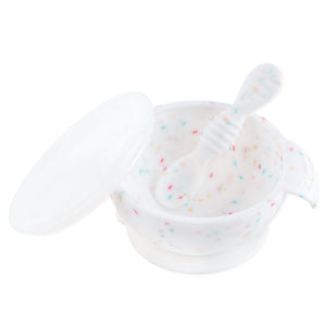 Bumkins Silicone First Feeding Set: Vanilla Sprinkle includes a white speckled bowl with secure suction base, matching spoon, and clear lid.