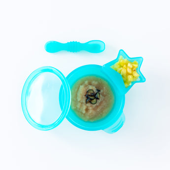 Bumkins Silicone First Feeding Set: Blue Jelly, with applesauce and berries, sits on a white background with a blue star-shaped cup of fruit.