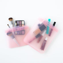 Load image into Gallery viewer, Bumkins Silicone Flat Reusable Bag 2 Pack, Pink holds makeup items on a white background.
