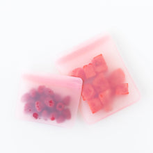 Load image into Gallery viewer, Bumkins Silicone Flat Reusable Bag 2 Pack, Pink holds fruit on a white background.
