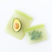 Load image into Gallery viewer, Bumkins Silicone Flat Reusable Bag 2 Pack, Sage stores avocado halves and chopped broccoli on a white background.
