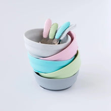 Load image into Gallery viewer, Five bowls and spoons, including Bumkins Silicone Grip Bowl: Gray, sit stacked on a white background.
