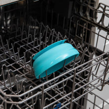 Load image into Gallery viewer, Bumkins Silicone Grip Bowl: Blue sits in the top rack of an open dishwasher.
