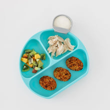 Load image into Gallery viewer, Bumkins Silicone Grip Dish: Blue holds chicken, fruit salad, and falafel on a white background, with a gray cup of white dip.
