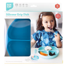 Load image into Gallery viewer, Bumkins Silicone Grip Dish: Dark Blue in a white packaging box with a photo of a child and a clear window partially displaying the dish.
