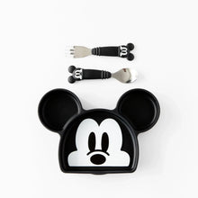 Load image into Gallery viewer, Bumkins Silicone Grip Dish: Mickey Mouse sits below a set of matching utensils on a white background.
