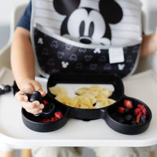Load image into Gallery viewer, Close-up of a toddler in a high chair enjoying bowtie pasta and berries from a Bumkins Silicone Grip Dish: Mickey Mouse with a spoon.
