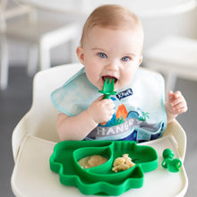 Load image into Gallery viewer, A baby in a highchair enjoys mashed food from a Bumkins Silicone Grip Dish, Special Edition: Dino, using a green fork &amp; wearing a blue bib.
