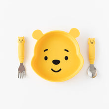Load image into Gallery viewer, Bumkins Spoon + Fork: Winnie the Pooh rests next to a Winnie the Pooh-shaped plate on a white background.

