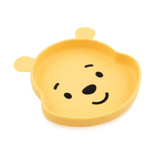Load image into Gallery viewer, Bumkins Silicone Grip Dish: Winnie The Pooh is a yellow bear-shaped silicone dish with one open section, a face, ears, and suction base.

