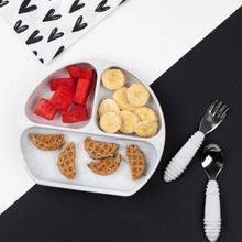 Load image into Gallery viewer, Bumkins Silicone Grip Dish: Gray holds fruit and waffles, with utensils on a black &amp; white background with a heart print pouch nearby.
