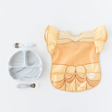 Load image into Gallery viewer, Bumkins Ruffle Apron Bib: Belle rests next to a gray marbled divided plate and matching utensils on a white background.
