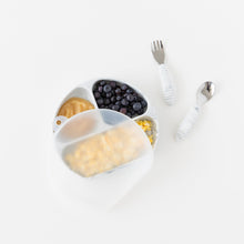 Load image into Gallery viewer, Bumkins Spoon + Fork: Marble rests next to a divided plate with fruit &amp; eggs with a transparent lid on a white background.
