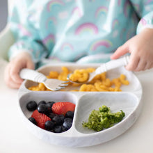 Load image into Gallery viewer, Close-up of a child in rainbow bib eating pasta, berries, and broccoli from a Bumkins Silicone Grip Dish: Marble using a fork and spoon.
