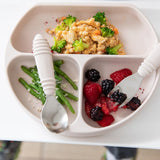 Close-up of Bumkins Silicone Grip Dish: Sand with couscous, broccoli, green beans, and berries, alongside a spoon and fork.