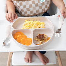 Load image into Gallery viewer, Close-up of a child in high chair holding a fork next to Bumkins Silicone Grip Dish: Sand with scrambled eggs, orange slices &amp; waffles.
