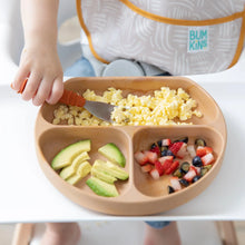 Load image into Gallery viewer, Close-up of a child in a high chair eating scrambled eggs, avocado, and fruit from Bumkins Silicone Grip Dish: Wood Grain with a fork.
