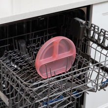 Load image into Gallery viewer, Bumkins Silicone Grip Dish: Pink Jelly sits in the top rack of an open dishwasher.
